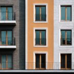 modern apartment building facade with balconies varied hues